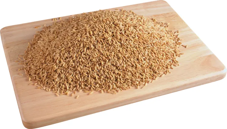 Heap of Uncooked Rice on Wooden Board