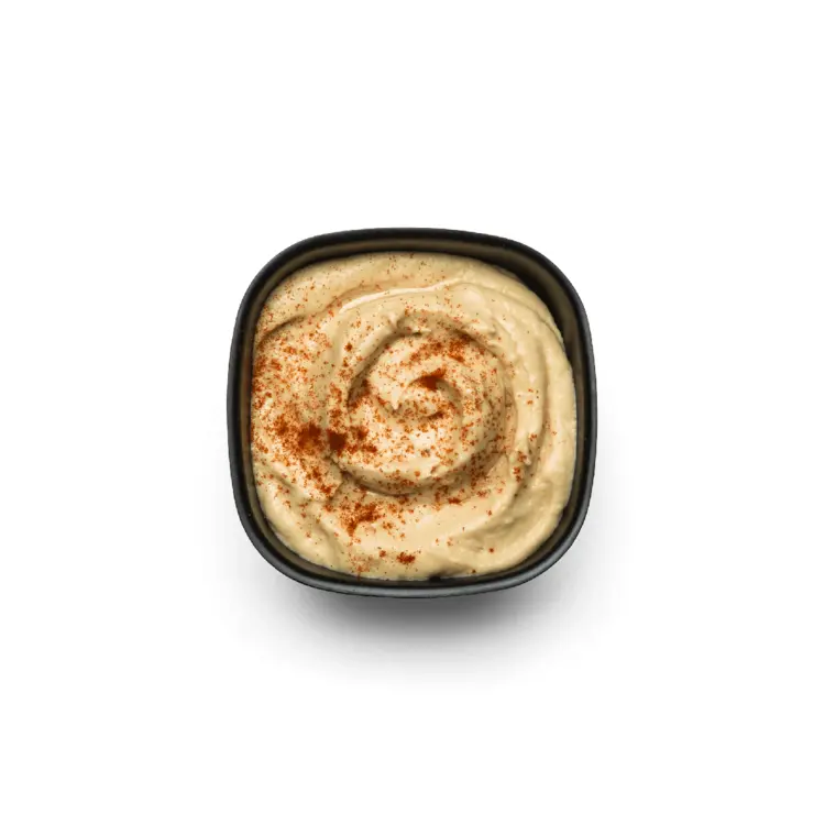 Hummus with Paprika in Black Bowl