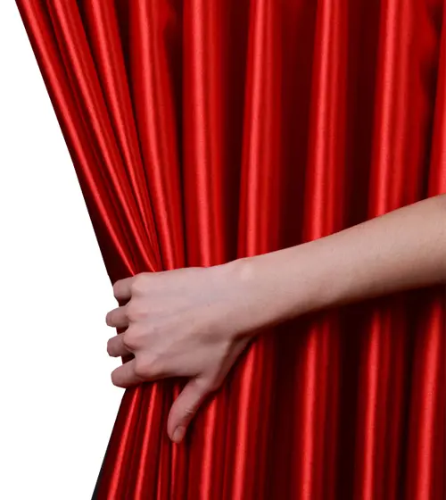 Hand Holding Red Theater Curtain