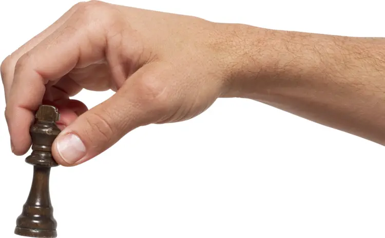 Hand Holding Chess Piece