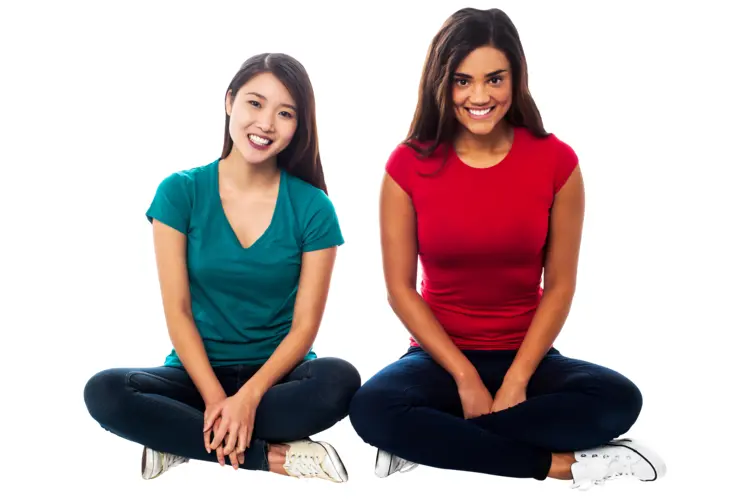 Two Women Sitting and Smiling