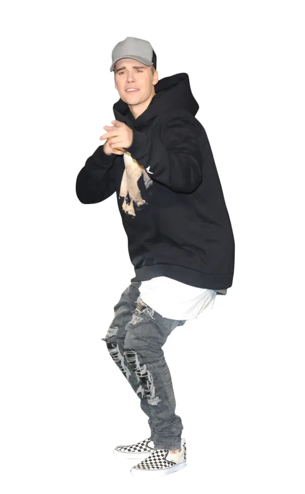 Person in Black Hoodie and Ripped Jeans Posing