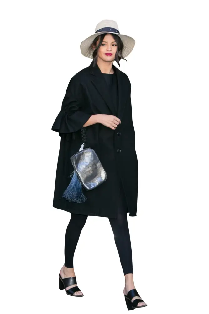 Stylish Woman in Black Coat and Hat Walking