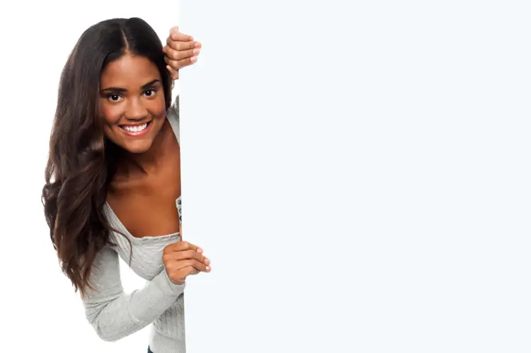 Smiling Woman Peeking from Behind Blank Sign