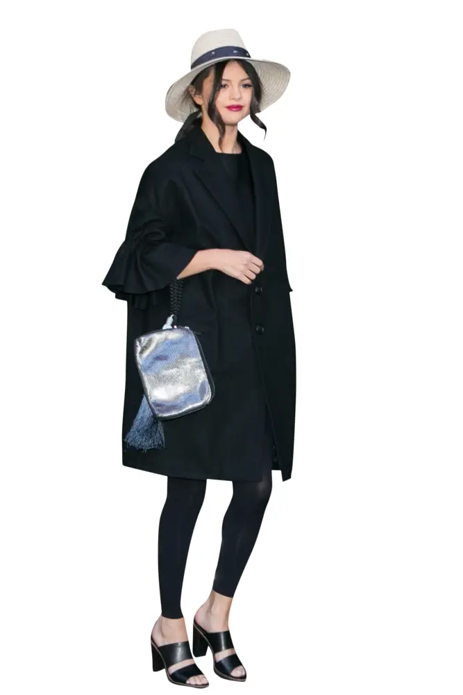 Stylish Woman in Black Coat with Hat and Bag