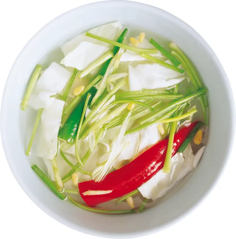Vegetable Soup with Red Pepper in a White Bowl