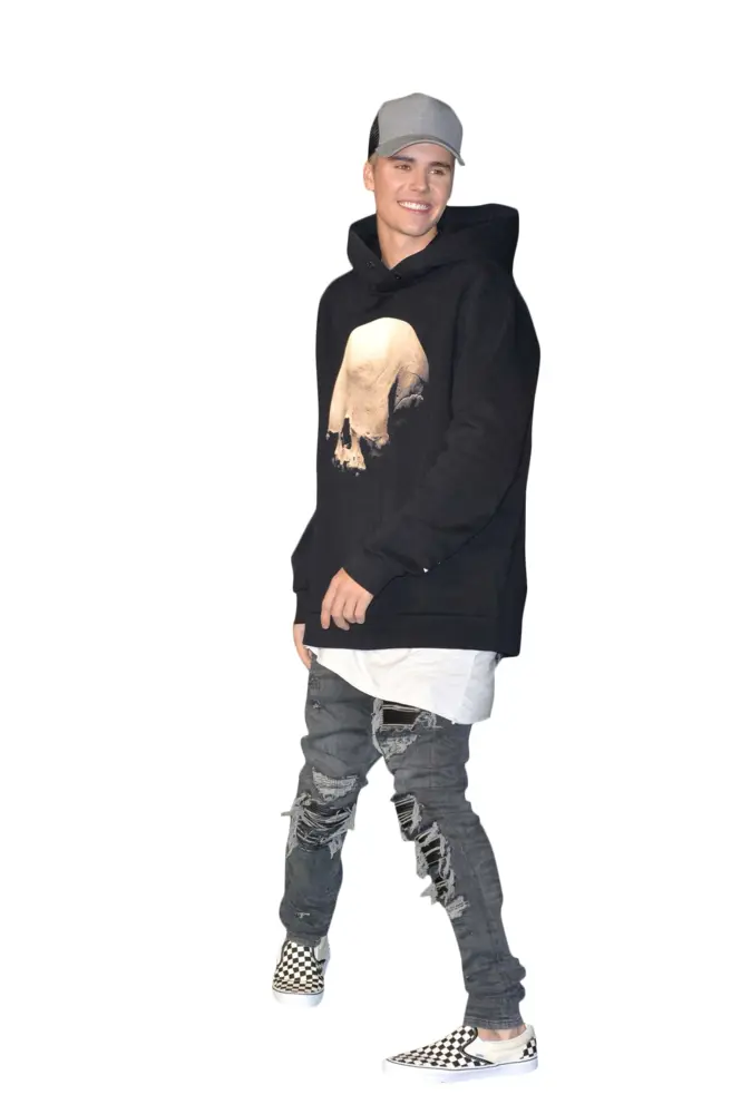 Person in Casual Outfit with Black Hoodie and Ripped Jeans