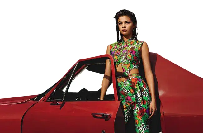 Woman in Colorful Green Dress by Red Car