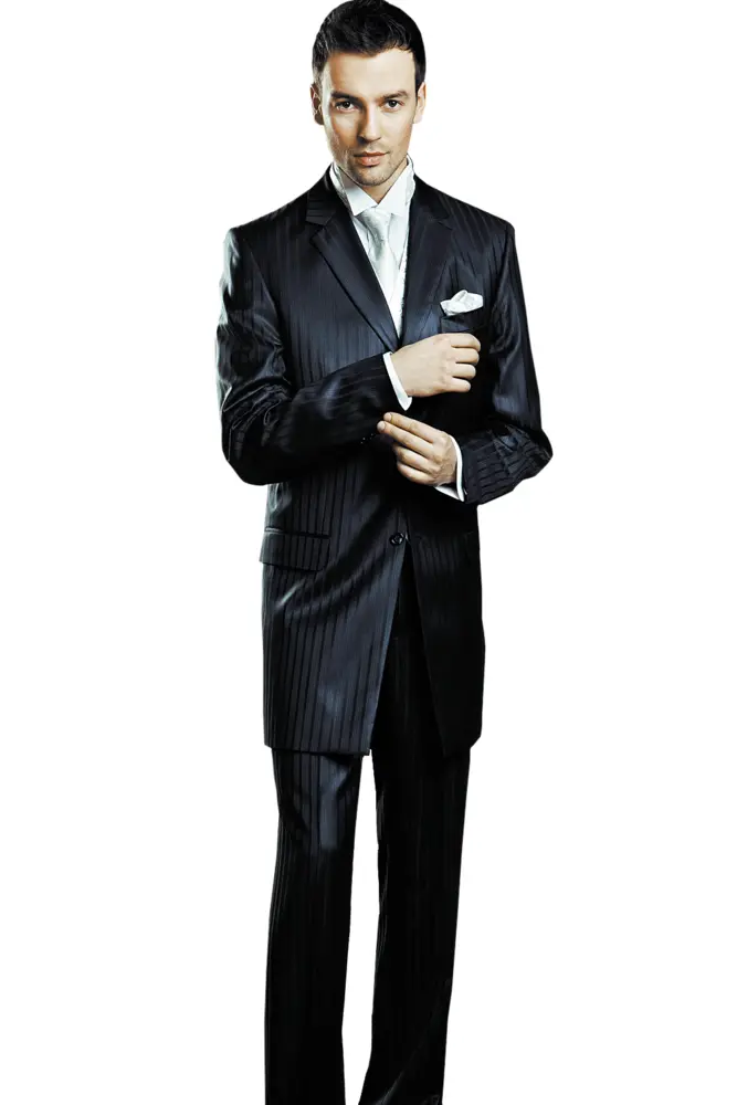 Man in Black Suit Adjusting Cufflinks