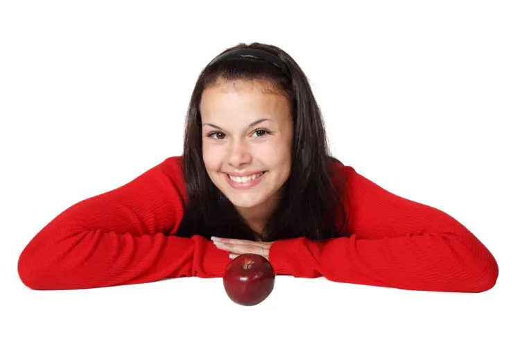Smiling Woman Leaning on Table with Red Apple