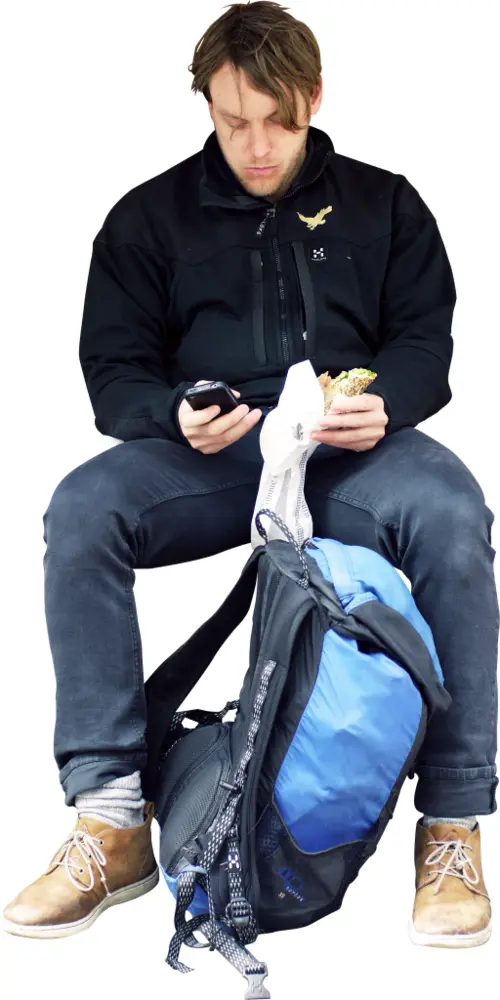 Man Sitting with Phone and Backpack