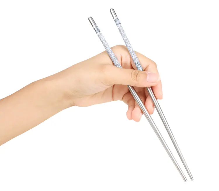 Hand Holding Metal Chopsticks with Pattern