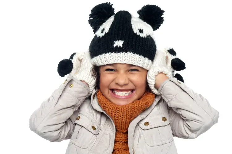 Girl in Winter Outfit Holding Hat