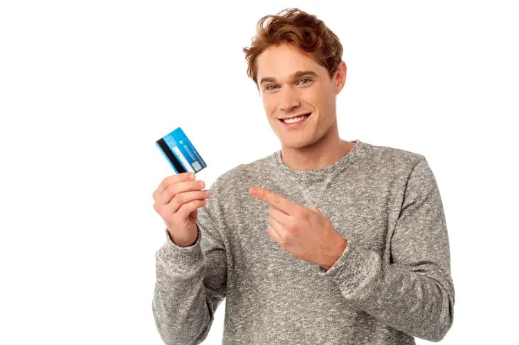 Smiling Man Holding and Pointing at Credit Card