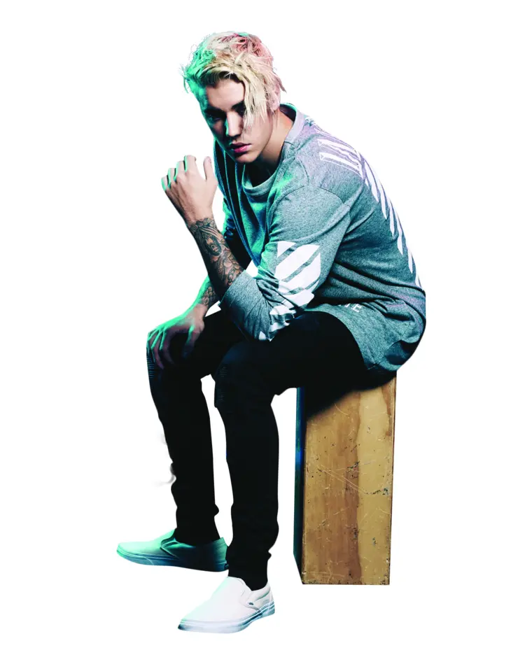 Tattooed Man in Grey Shirt Sitting