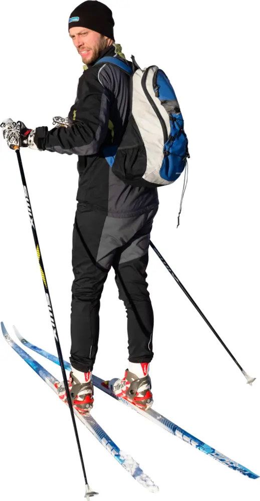 Cross-Country Skier with Backpack in Winter Landscape