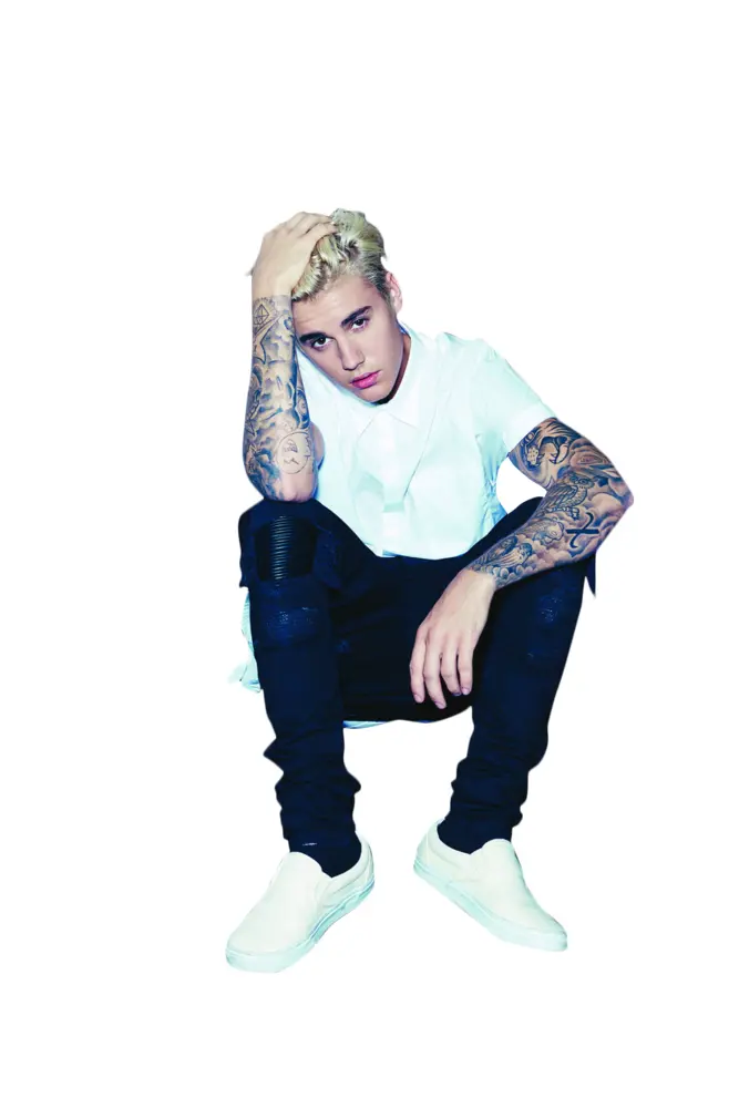 Tattooed Man in White Shirt Sitting