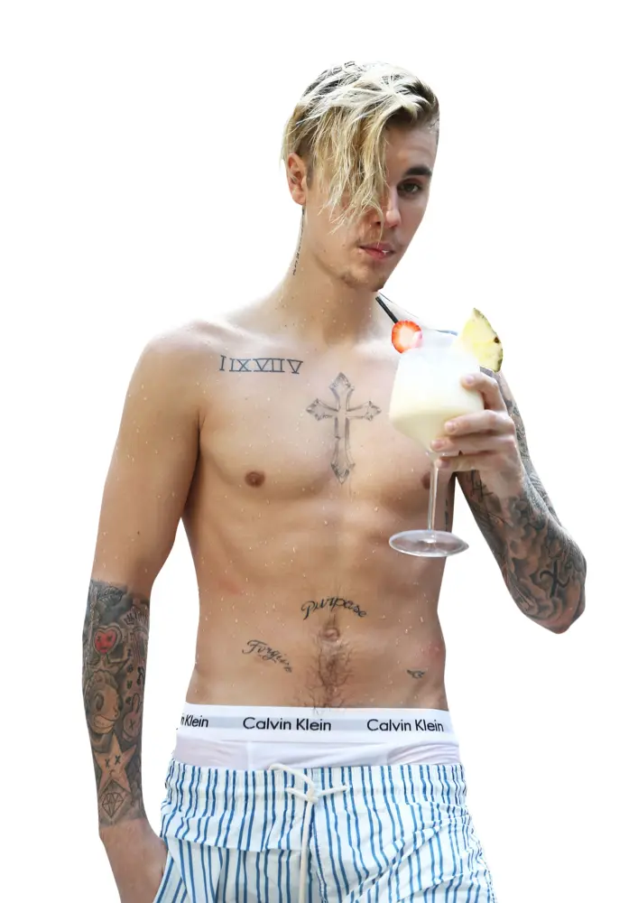 Shirtless Man with Tattoos Holding a Drink