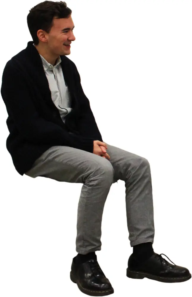 Smiling Man Sitting Indoors