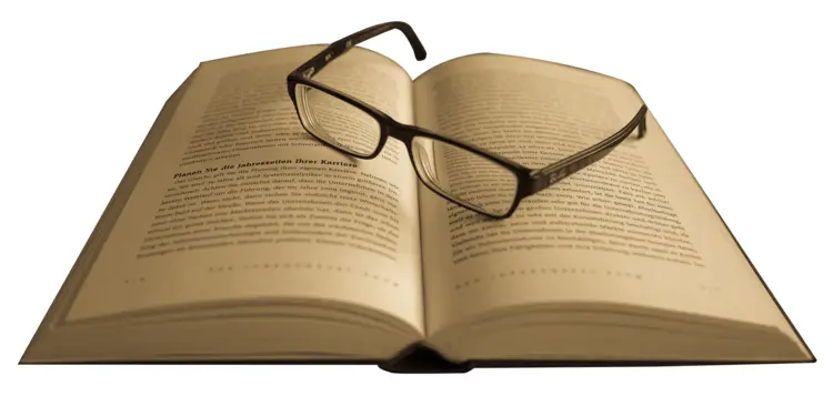 Open Book with Glasses Resting on Top