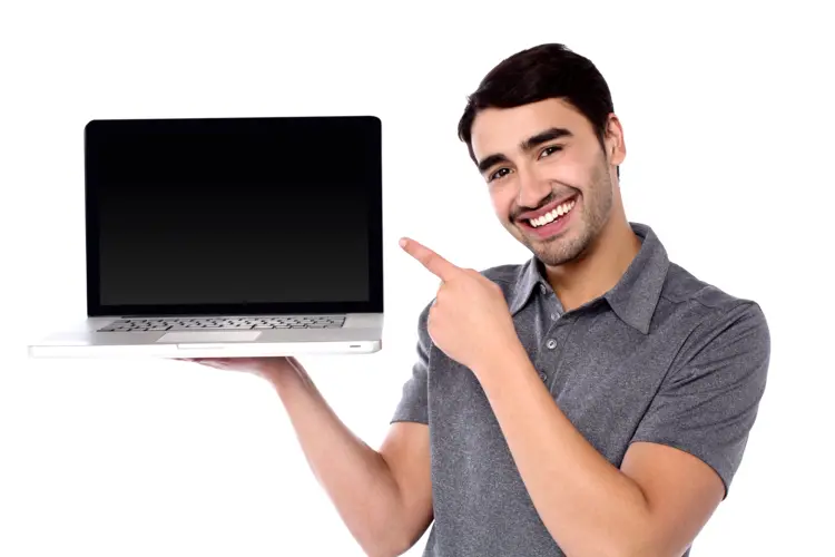Man in Grey Shirt Holding a Laptop