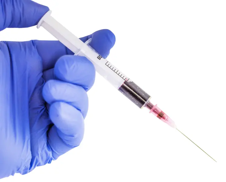 Syringe with Blood in Medical Glove
