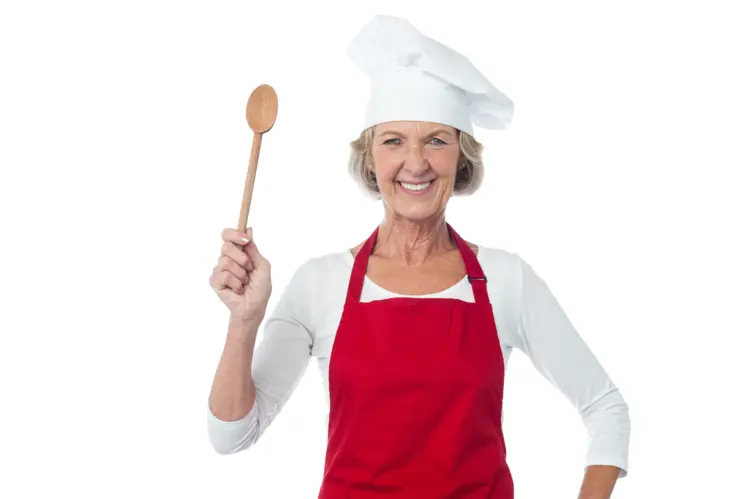 Smiling Woman in Chef Hat and Red Apron