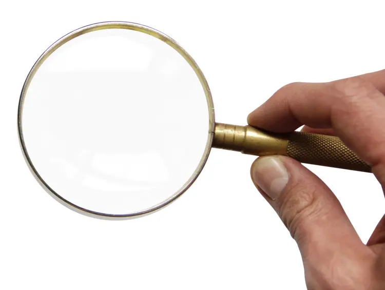 Hand Holding Magnifying Glass for Inspection