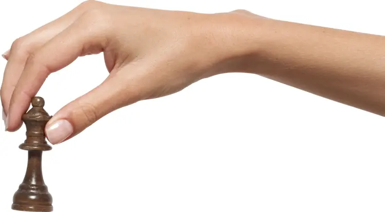 Hand Holding Chess Piece