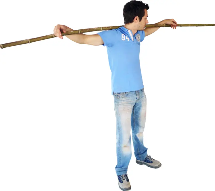 Man Holding Bamboo Stick in Action Pose