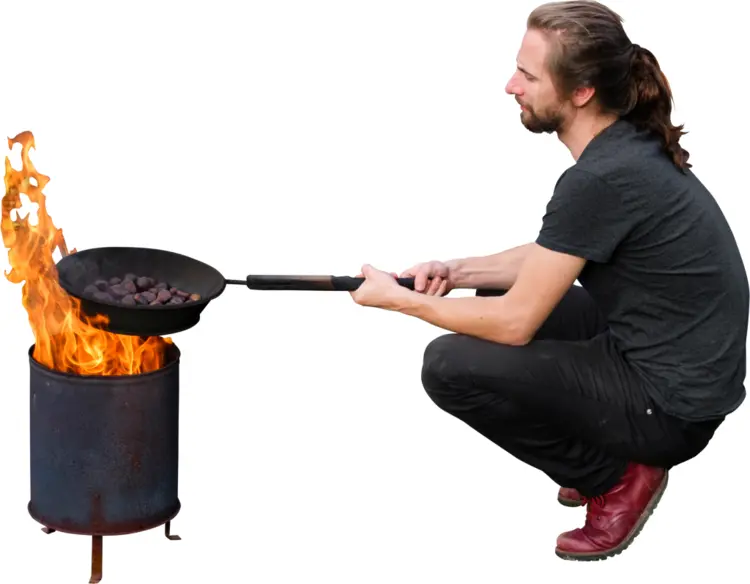 Man Cooking Over Fire