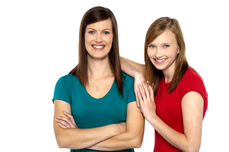 Two Women Smiling and Standing Together