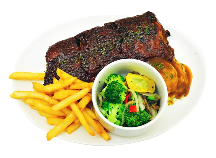 Delicious Ribs Plate with Fries and Vegetables