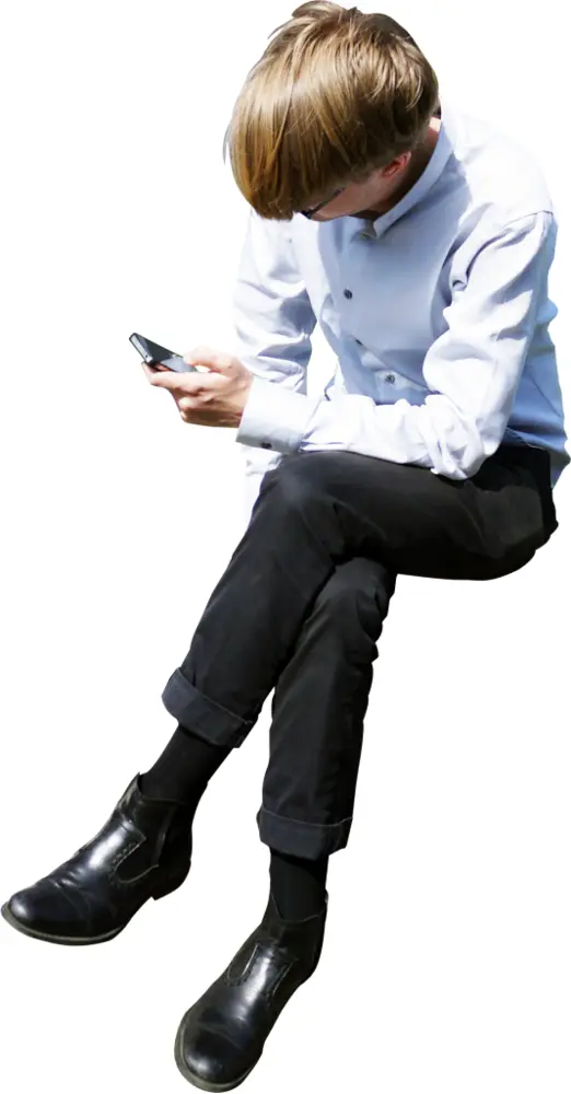 Man Sitting and Using Phone
