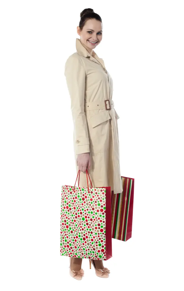 Woman with Shopping Bags in Trench Coat