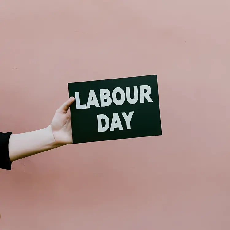 Hand Holding Labour Day Sign