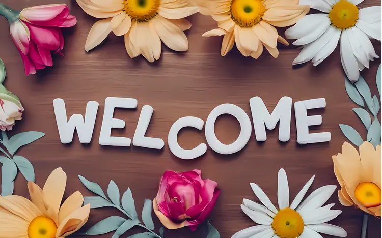Welcome Text with Flowers on Wooden Background