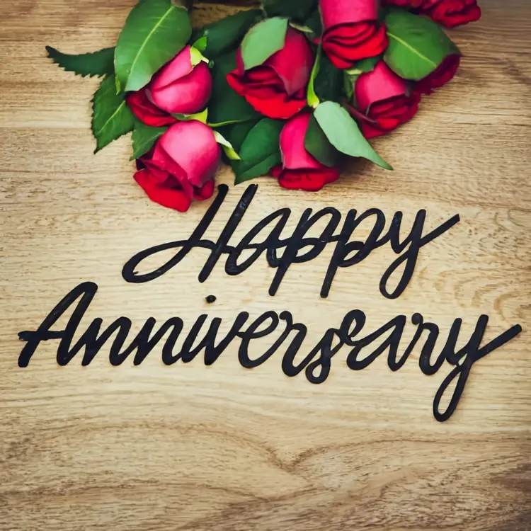 Happy Anniversary with Red Roses on Wooden Background