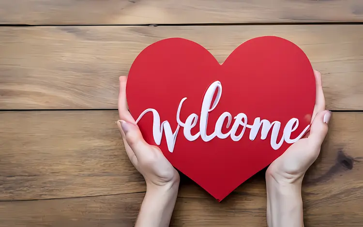 Welcome Text on Heart Held by Hands