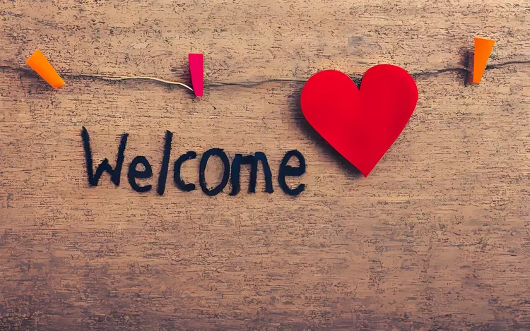 Welcome Text with Hanging Heart on Wall