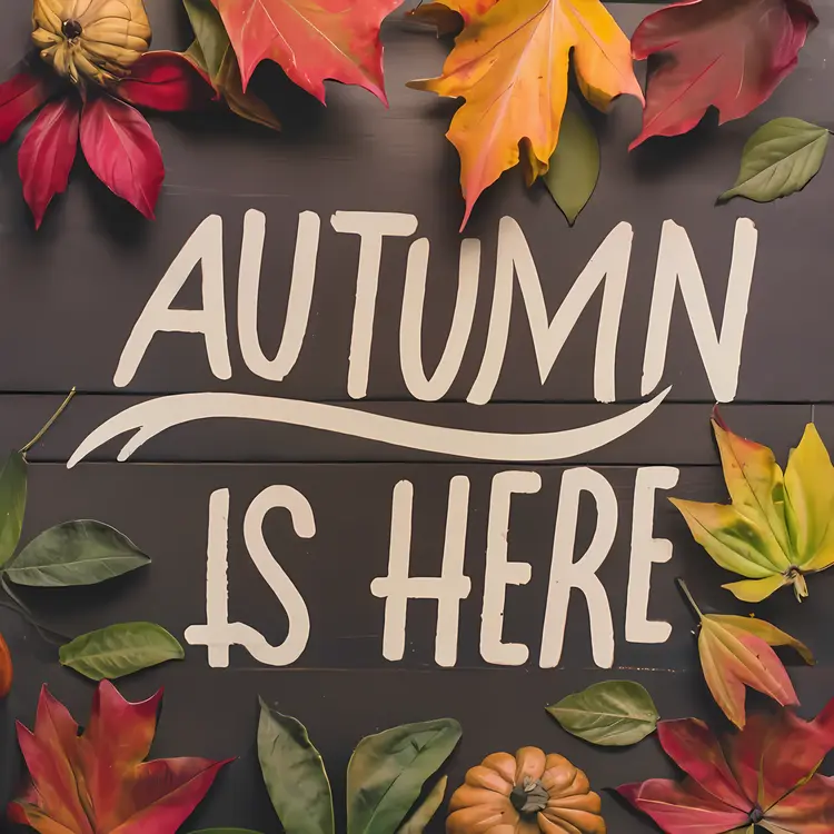 Autumn is Here Text with Leaves and Pumpkins